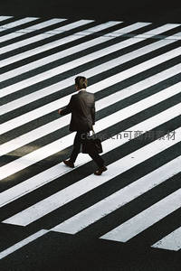 西装男子背影走过斑马线