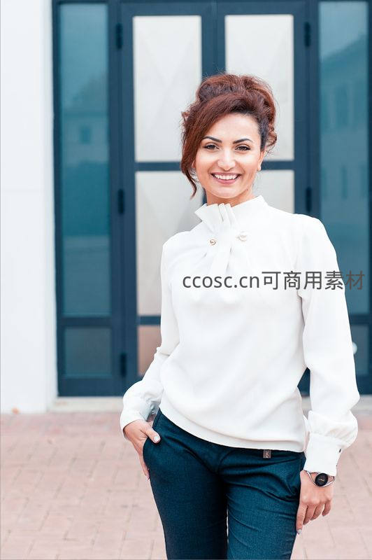优雅女士身穿白衬衫微笑站立