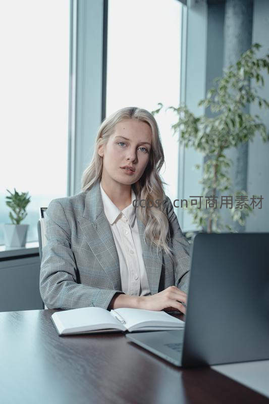 金发女白领专注使用笔记本电脑
