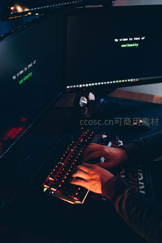暗光下程序员敲击发光键盘