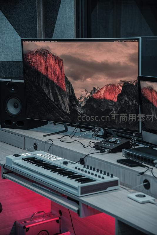 专业音乐制作台上的键盘与双屏设备