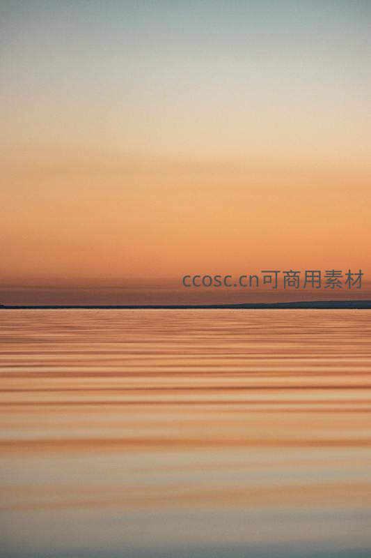 夕阳余晖洒满平静无垠的湖面