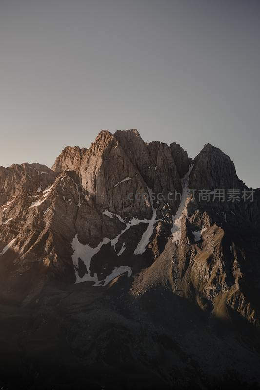 夕阳余晖洒在嶙峋山峰之上