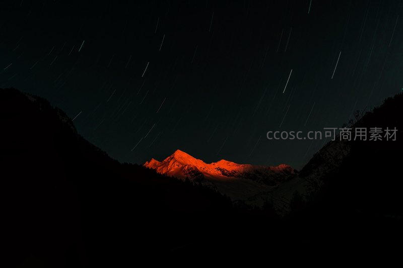 星轨绕雪峰，赤光耀夜空