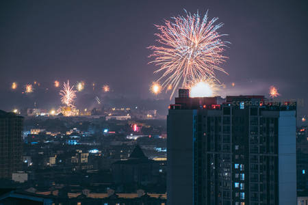夜空绽放的绚烂烟花照亮城市天际线