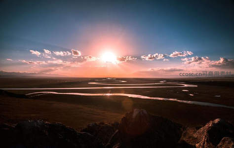 夕阳西下，蜿蜒河流穿越草原