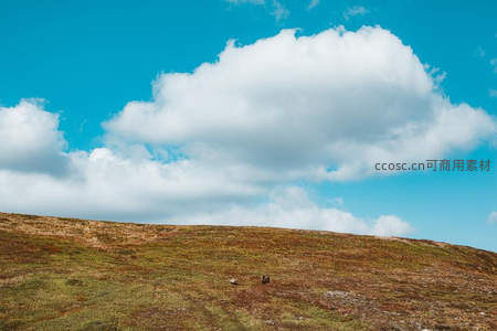 蓝天白云下空旷丘陵无垠