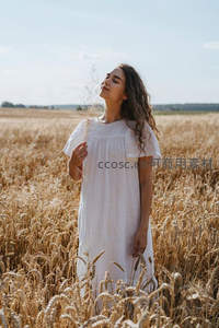 麦田里闭目享受阳光的白衣少女