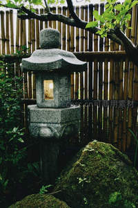 日式石灯笼静立竹篱旁，苔藓点缀古韵悠长