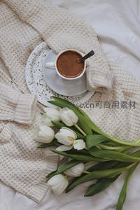 针织毛衣旁的咖啡与白郁金香