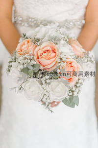 新娘手捧粉白玫瑰花束特写