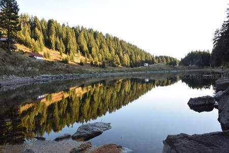 林间湖泊如镜倒影，晨光洒落静谧山谷