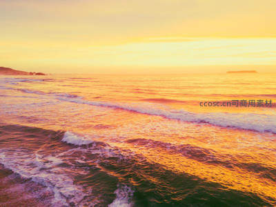 梦幻橙黄海面，温柔浪花轻抚沙滩如画境