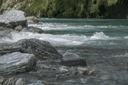 急流拍打层叠岩，水花飞溅显自然之力