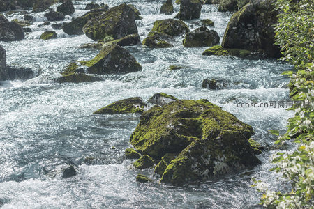 青苔覆盖巨石静卧激流之中