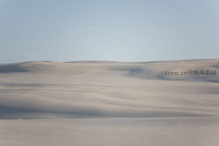 广袤沙丘在晴空下延绵起伏