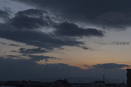 城市上空乌云密布，夕阳欲坠山峦