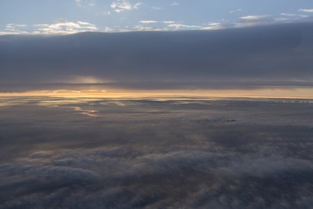 高空俯视云层如海，晨曦为浪花镀上金边
