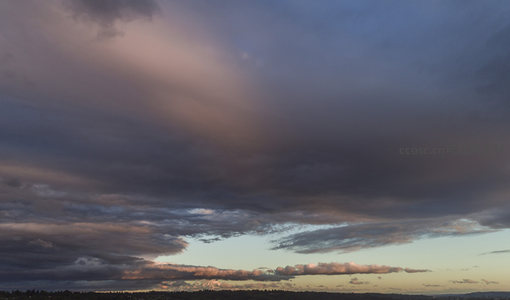 暮色苍穹云层翻涌，霞光穿透天际线