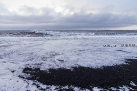 白沫覆黑沙，潮退留痕，云压海平线
