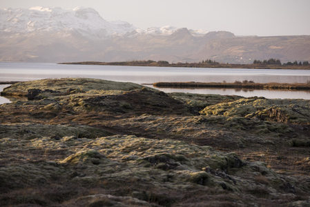 湖畔苔藓丘陵与远山倒影