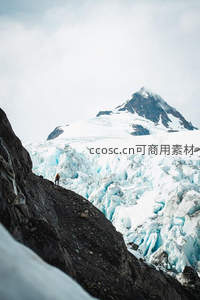 登山者站在冰川边缘，远眺雪山之巅