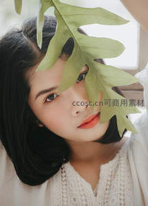绿叶遮面的温柔少女特写