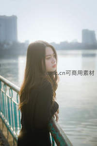 湖畔栏杆边沉思的长发女孩