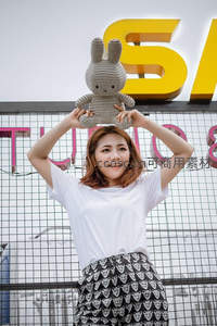 少女举兔玩偶微笑街拍