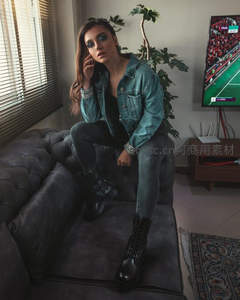 客厅沙发上的牛仔女孩专注观赛