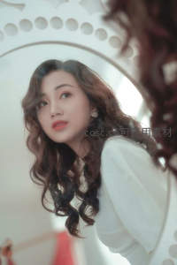 镜前卷发女子温柔侧颜