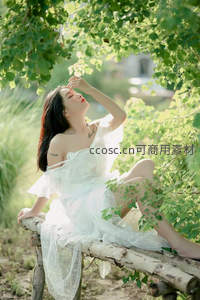 绿荫下的白衣女子闭目享受阳光