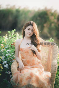 花丛中的温柔凝视，橙裙少女静享午后