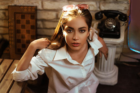 复古砖墙前的时尚女性肖像