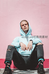 粉墙前破洞牛仔裤潮男坐姿