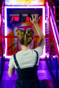 霓虹灯下投篮少女，青春活力闪耀游戏厅