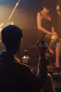 昏暗酒吧中沉思的绅士与舞台女郎