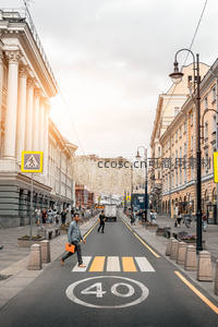 阳光洒落的欧式街道，行人漫步于历史建筑间