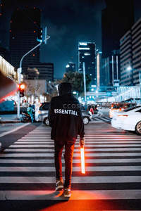 夜幕下持光棒行人穿越霓虹街头