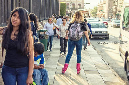 街头行人熙攘，阳光洒满城市步道