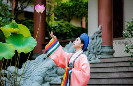 粉衣女子庭院轻触荷花