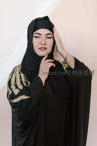 黑衣女子手抚头巾眼神深邃沉静