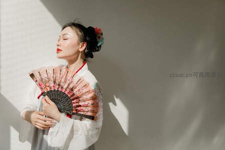 光影之间，古典美人执扇沉思