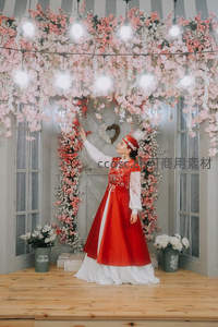 花海拱门下红裙女子仰望灯饰