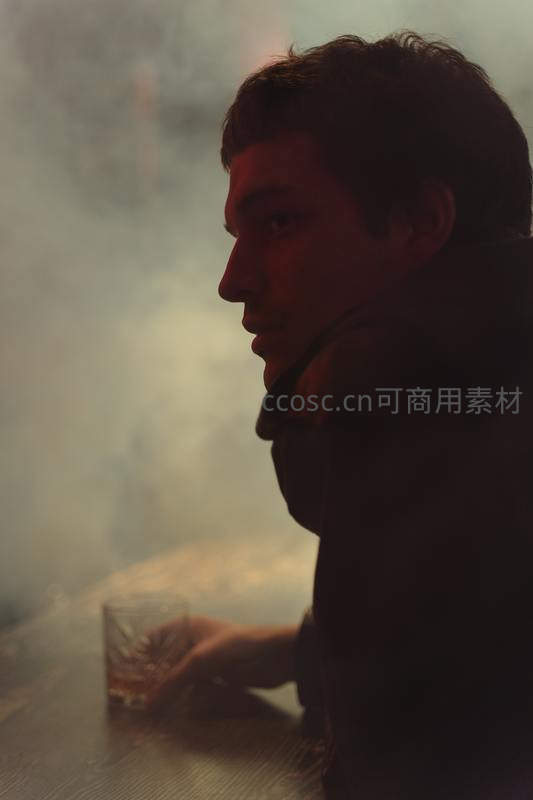 烟雾缭绕中男子独酌沉思