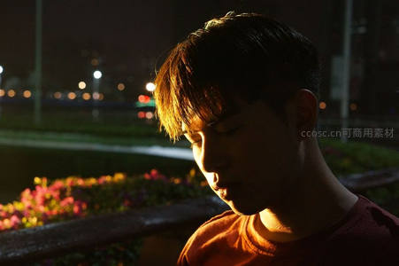 夜色中少年侧脸被暖光温柔照亮