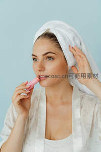 浴后女子头裹毛巾，轻涂粉色润唇膏