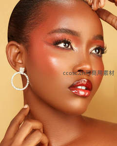 黑人女性浓妆特写，闪亮耳环衬托红唇眼影