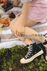 野餐少女腿上纹身与帆布鞋
