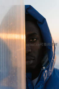 蓝衣男子透过玻璃凝视远方